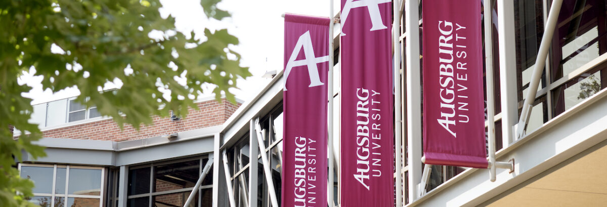 Maroon "Augsburg University" banners outdoors